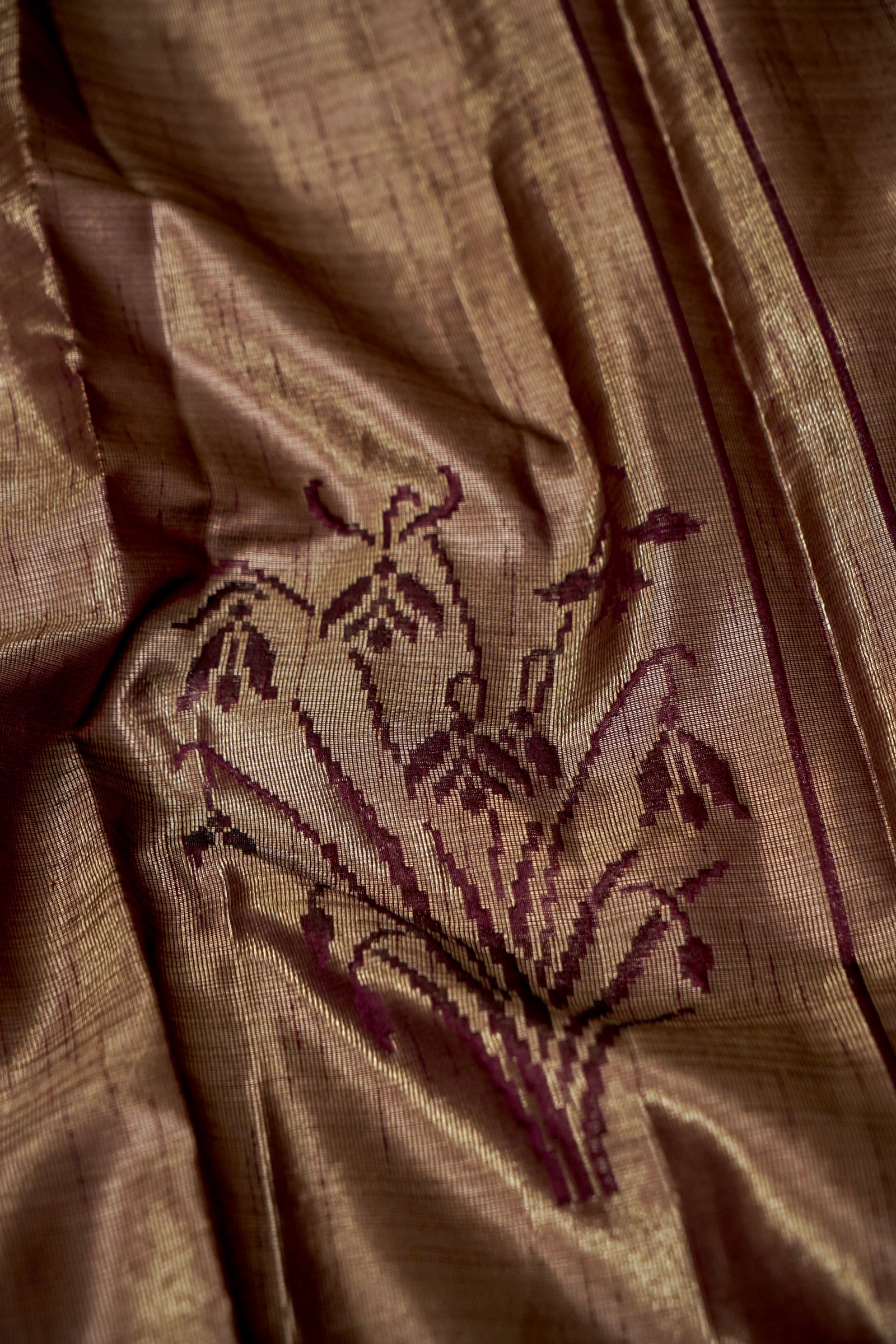 Tissue Silk Saree with Ikat-Inspired Weaving & Floral Buta – Antique Gold & Wine
