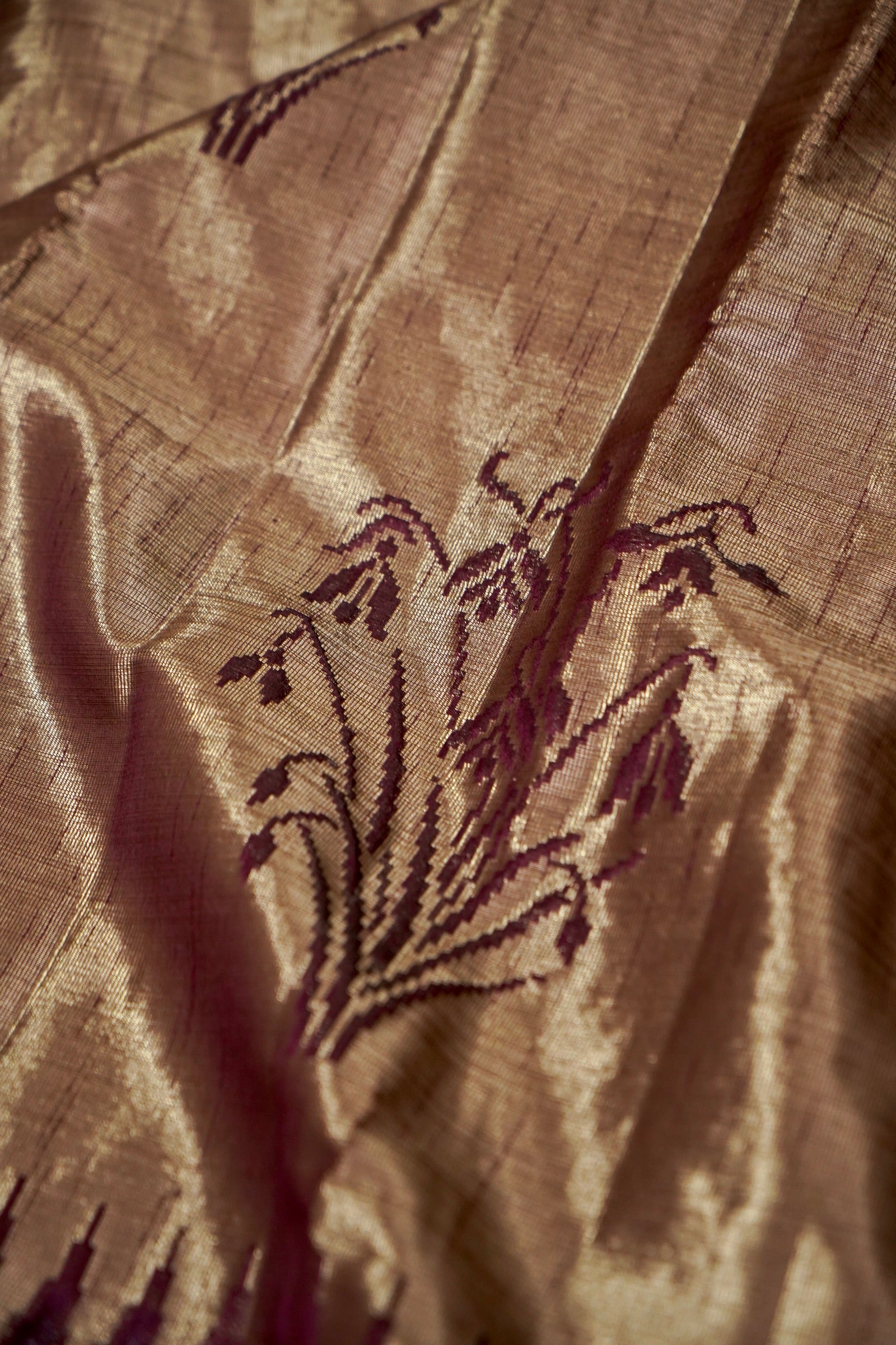 Tissue Silk Saree with Ikat-Inspired Weaving & Floral Buta – Antique Gold & Wine